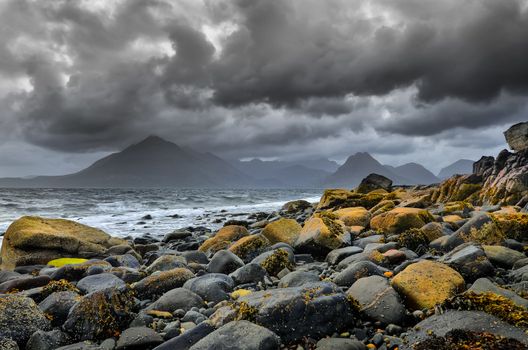 Landscape coastline view of rocks and Cullin hills, Scotland, United Kingdom