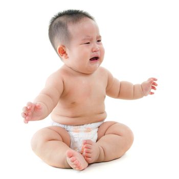 Full body Asian baby boy crying, sitting isolated on white background