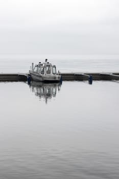 Solitary boat in a harbor, on a calm day.