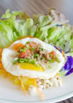 close up fried egg with minced pork and  fresh salad on dish