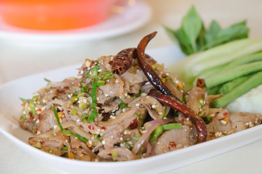 spicy minced pork eaten with  fresh vegetable on white plate