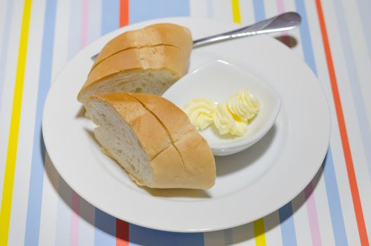 top view cheese in bowl  and slice of bread on white plate