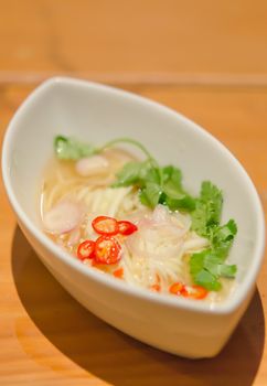 spicy green mango salad with slices chili   in white bowl