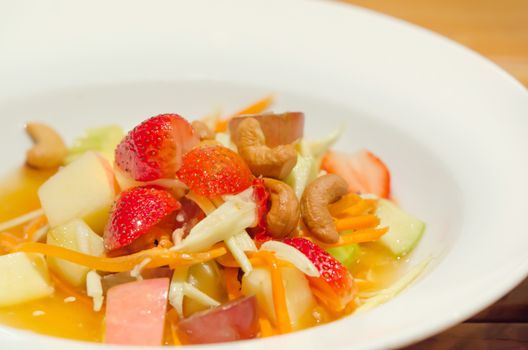 spicy mix  fruits salad , asian style  cuisine on white dish