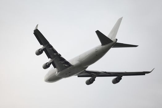 Huge plane taking off to overcast sky