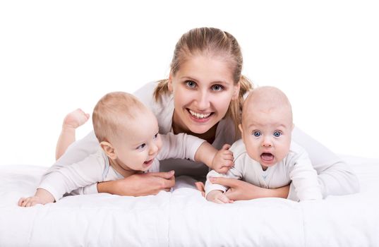 Smiling young woman with two baby boys over white
