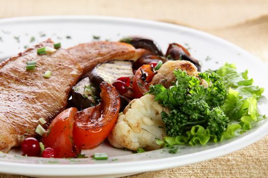 roated meat with mushrooms and vegetables on white dish