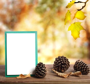 Autumn greeting card with pine cones in shiny forest background