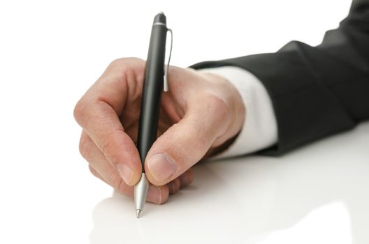 Closeup of businessman hand writing on copy space.