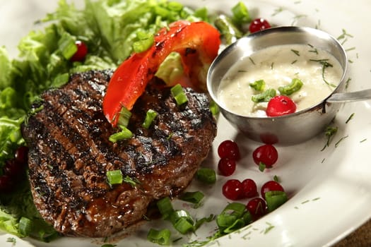 grilled meat in white dish with souce