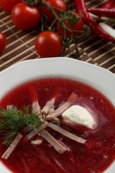 Cold and fresh soup with meat on the wooden table