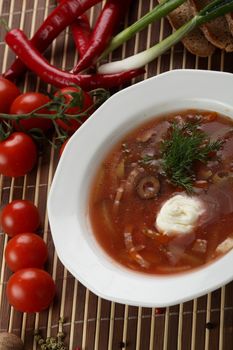 Cold and fresh soup with meat on the wooden table