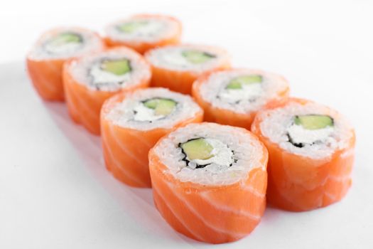 fresh and tasty sushi on bright background