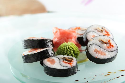 fresh and tasty sushi on bright background