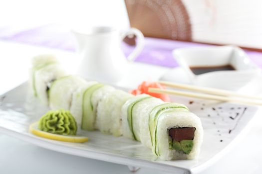 fresh and tasty sushi on bright background