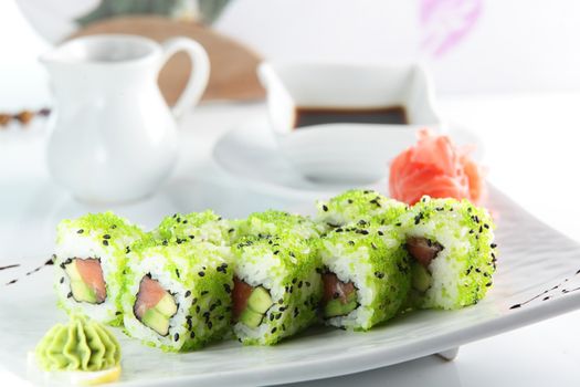 fresh and tasty sushi on bright background