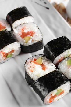 fresh and tasty sushi on bright background