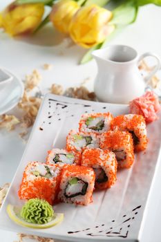 fresh and tasty sushi on bright background