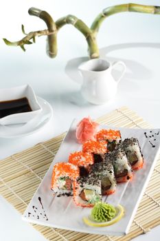 fresh and tasty sushi on bright background