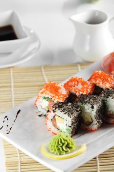 fresh and tasty sushi on bright background