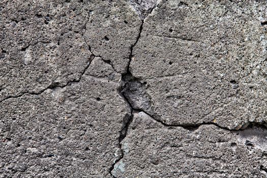 Large cracked stone wall background texture