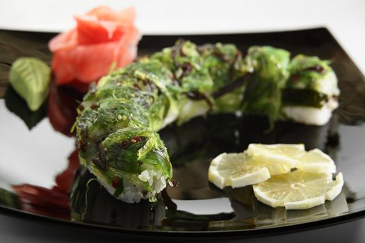 cold sushi on black dish and white background