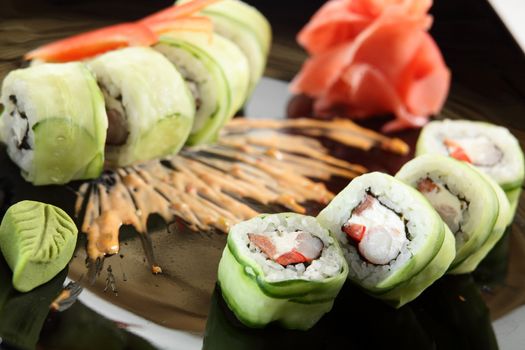 cold sushi on black dish and white background