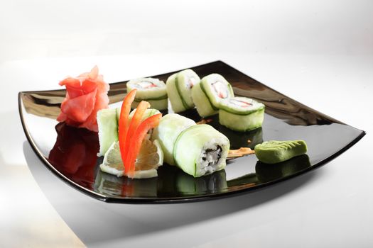 cold sushi on black dish and white background