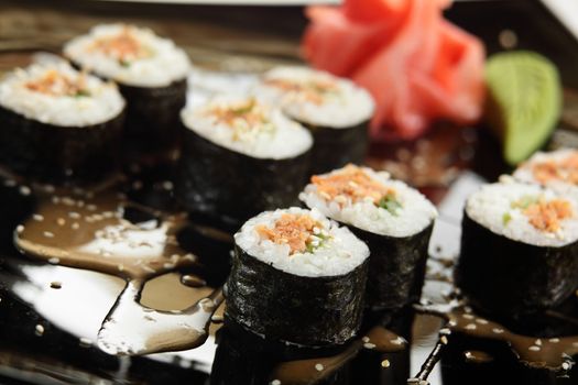 cold sushi on black dish and white background