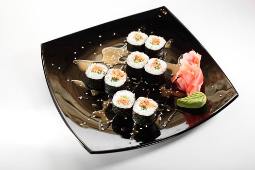 cold sushi on black dish and white background