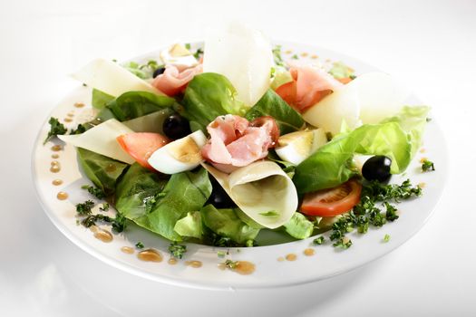 fresh and tasty european salad on white dish