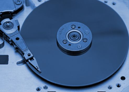 Open computer hard drive on white background with blue (HDD, Winchester)