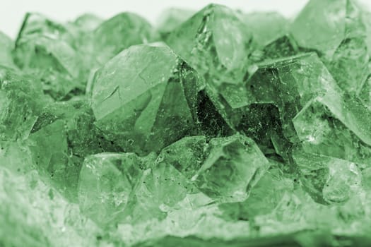 Close up picture about a crystal with emerald color on white background (green crystal)