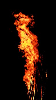 red flames of huge bonfire or campfire as black backgorund