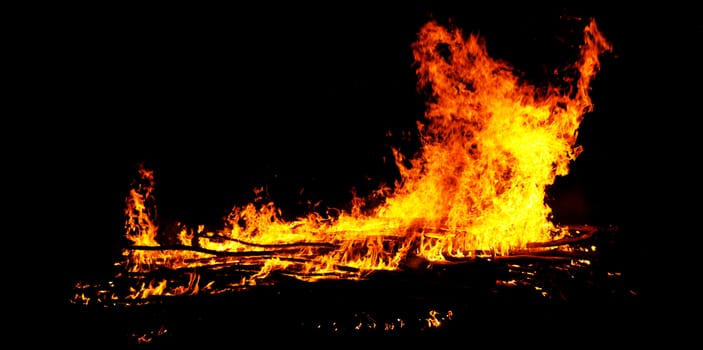 red flames of huge bonfire or campfire as black backgorund