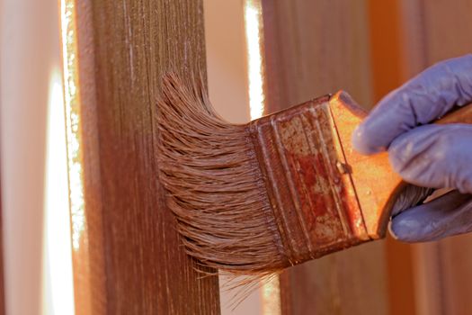 planks fence dyeing with brown paint and brush