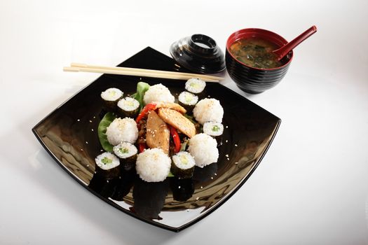 cold sushi on black dish and white background