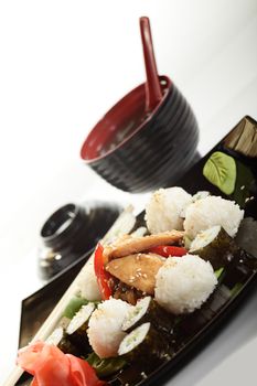 cold sushi on black dish and white background