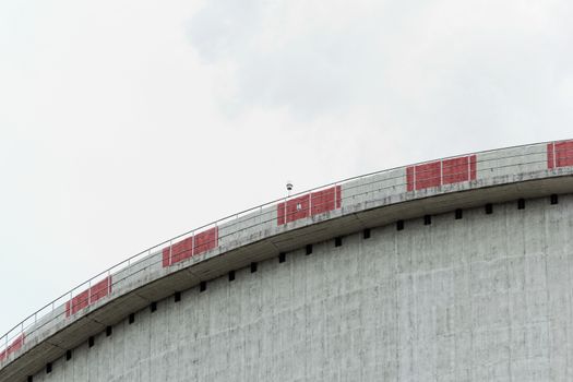 The top of the power plant cooling tower, painted white with red