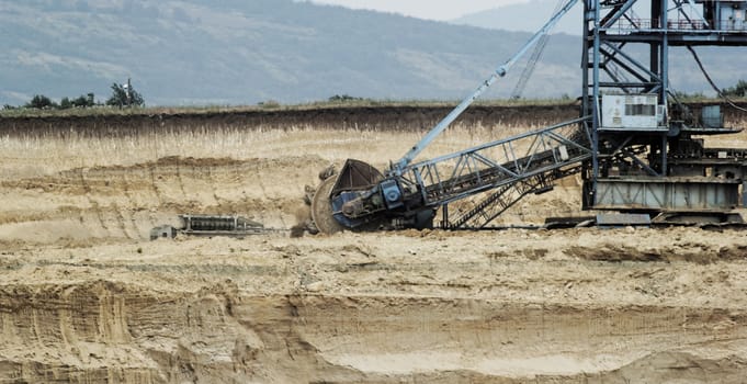 Coal mining in an open pit with huge industrial machine