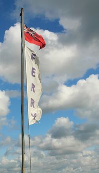 Image of a commuter ferry flag, flying in a storm with clouds