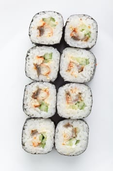 fresh and tasty sushi on white reflective background