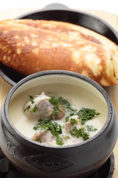 hot roasted meat with pancake and mushrooms on wooden desk