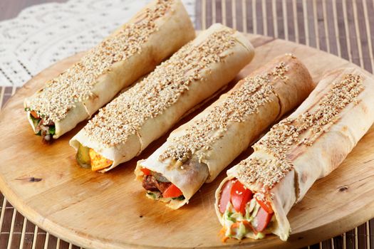 hot fresh and tasty shawarma with vegetables on wooden background