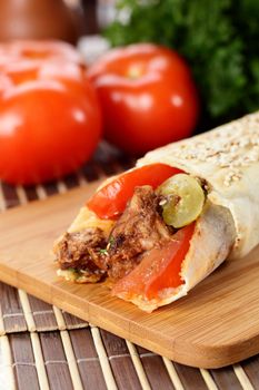 hot fresh and tasty shawarma with vegetables on wooden background