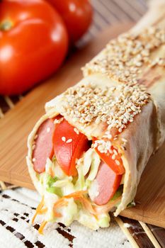 hot fresh and tasty shawarma with vegetables on wooden background