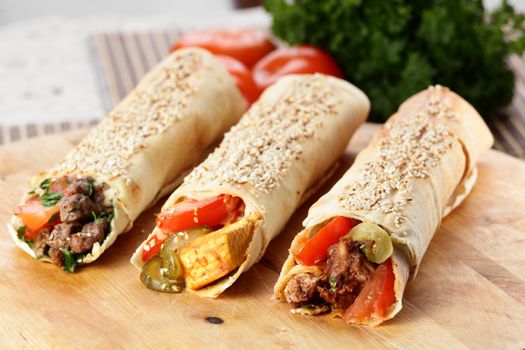 hot fresh and tasty shawarma with vegetables on wooden background