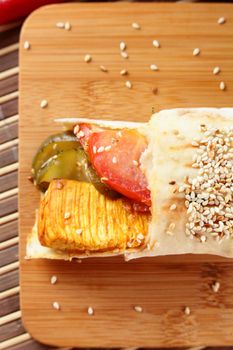 hot fresh and tasty shawarma with vegetables on wooden background