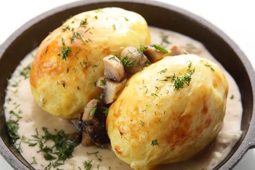 hot roasted potato with mushrooms on white background