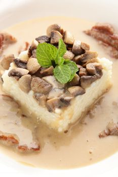 hot roasted meat with rice and mushrooms on white background